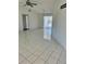 Bright living room featuring tile flooring, ceiling fan, and sliding glass doors to the outdoor area at 2259 Lee Ter, Port Charlotte, FL 33952