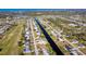 Aerial view of home on canal with gulf access and neighborhood at 235 Caddy Rd, Rotonda West, FL 33947