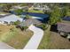 Aerial view of home with long driveway and canal in the backyard at 235 Caddy Rd, Rotonda West, FL 33947