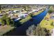 Aerial view of homes on canal with neighborhood at 235 Caddy Rd, Rotonda West, FL 33947
