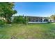 Lush backyard with mature trees and screened-in patio at 235 Caddy Rd, Rotonda West, FL 33947