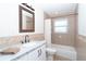 Neutral bathroom with a shower and tub combination, single sink vanity and a large framed mirror at 235 Caddy Rd, Rotonda West, FL 33947