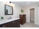 Tastefully updated bathroom featuring a marble vanity, dark wood cabinet, and a view into the spacious bedroom at 235 Caddy Rd, Rotonda West, FL 33947