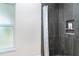 Modern bathroom with a tiled shower, sleek design and built in shelves for optimal organization and style at 235 Caddy Rd, Rotonda West, FL 33947