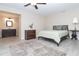 Neutral bedroom with a queen bed, wood furniture, tile floors and an adjacent bathroom for convenience and comfort at 235 Caddy Rd, Rotonda West, FL 33947