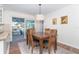 Cozy dining area featuring a wood table and chairs, natural light, and sliding glass door to the outdoor patio at 235 Caddy Rd, Rotonda West, FL 33947