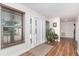Bright entryway featuring wood floors, a stylish rug, and a view to the front door at 235 Caddy Rd, Rotonda West, FL 33947