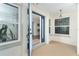 Open blue front door showcasing the entry with sidelight windows and a welcoming interior view at 235 Caddy Rd, Rotonda West, FL 33947