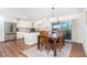 Open kitchen featuring stainless steel appliances, granite countertops, and a dining area with sliding glass doors at 235 Caddy Rd, Rotonda West, FL 33947