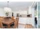 Bright kitchen and dining area, with white cabinets, stainless steel appliances, and sliding glass door access to the patio at 235 Caddy Rd, Rotonda West, FL 33947