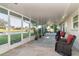 Spacious screened-in patio with outdoor furniture and scenic backyard view at 235 Caddy Rd, Rotonda West, FL 33947