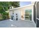 Enclosed patio featuring tropical plants and glass slider to bedroom at 235 Caddy Rd, Rotonda West, FL 33947