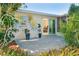 Enclosed patio featuring tropical plants and glass slider to office space at 235 Caddy Rd, Rotonda West, FL 33947