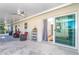 Spacious covered patio with ceiling fan and comfortable seating, perfect for enjoying outdoor living and entertaining at 235 Caddy Rd, Rotonda West, FL 33947