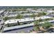 An aerial of a desirable condo community featuring mature trees, assigned parking, and landscaping at 2437 Harbor Blvd # 204, Port Charlotte, FL 33952