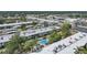 Aerial view of condos, community pool, mature trees, and landscaping at 2437 Harbor Blvd # 204, Port Charlotte, FL 33952