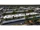 Aerial view of the community showcasing multiple units, a community pool, landscaping, and parking at 2437 Harbor Blvd # 204, Port Charlotte, FL 33952