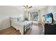 Bedroom featuring a black iron bed frame, wood floors, and a window with natural light at 2437 Harbor Blvd # 204, Port Charlotte, FL 33952