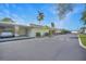Well maintained condo building exterior with palm trees and covered parking on a sunny day at 2437 Harbor Blvd # 204, Port Charlotte, FL 33952