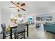 Bright living room featuring a dining table, fan and plank flooring at 2437 Harbor Blvd # 204, Port Charlotte, FL 33952