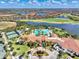 Beautiful scenery from the air includes pool, tennis and pickleball courts, and clubhouse at 25207 Spartina, Venice, FL 34293