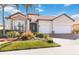 Beautiful home with a tile roof, three-car garage, a paver driveway, and lush landscaping at 25207 Spartina, Venice, FL 34293