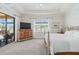 Main bedroom featuring a bed, dresser, large window with outdoor views, and access to a covered patio at 25207 Spartina, Venice, FL 34293