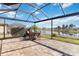 Relaxing covered patio overlooking a serene lake with lush landscaping at 25207 Spartina, Venice, FL 34293