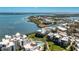 Beautiful aerial view of waterfront condos, pool, marina, and lush landscaping, offering resort-style living at 2955 N Beach Rd # D123, Englewood, FL 34223