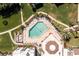 Aerial view of the community pool surrounded by palm trees, lounge chairs, and manicured grounds at 2955 N Beach Rd # D123, Englewood, FL 34223