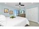 Inviting bedroom with a soft bed, a large window revealing water views, and ample storage with double closet doors at 2955 N Beach Rd # D123, Englewood, FL 34223