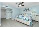 Inviting bedroom with a ceiling fan, closet, and tranquil decor, offering a relaxing retreat at 2955 N Beach Rd # D123, Englewood, FL 34223