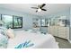 Sunlit bedroom features two windows that illuminate a comfortable bed with tropical-themed decor and bright natural light at 2955 N Beach Rd # D123, Englewood, FL 34223