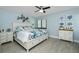 Serene bedroom boasts a comfortable bed with stylish bedding, complemented by coastal-inspired decor and ample storage at 2955 N Beach Rd # D123, Englewood, FL 34223