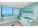 Bedroom with water views, daybed and coastal decor providing a peaceful and bright retreat at 2955 N Beach Rd # D123, Englewood, FL 34223