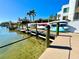 A variety of kayaks and boats are stored on a well-maintained dock with clear water at 2955 N Beach Rd # D123, Englewood, FL 34223
