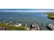 Scenic view of boat docks on calm water with clear skies and lush greenery at 2955 N Beach Rd # D123, Englewood, FL 34223