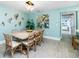 Charming dining room features a light wood table, seating for eight, and coastal-inspired decor at 2955 N Beach Rd # D123, Englewood, FL 34223