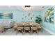 Dining room has seating for eight, coastal decor and artwork, and an adjacent living area at 2955 N Beach Rd # D123, Englewood, FL 34223