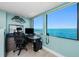 Home office with water views, functional desk setup, and abundant natural light creating a productive workspace at 2955 N Beach Rd # D123, Englewood, FL 34223