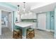 Bright, updated kitchen with breakfast bar and access to entryway and hallway at 2955 N Beach Rd # D123, Englewood, FL 34223