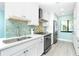 Modern kitchen featuring stainless appliances, white cabinets, and tile backsplash at 2955 N Beach Rd # D123, Englewood, FL 34223