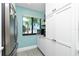 Well-lit kitchen features a modern stainless steel refrigerator and a window view of tropical palm trees at 2955 N Beach Rd # D123, Englewood, FL 34223