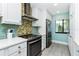 Well-equipped kitchen featuring a modern stove, stainless steel refrigerator, and ample cabinetry at 2955 N Beach Rd # D123, Englewood, FL 34223