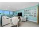 Bright living room with ocean views, comfortable seating, and a coastal-themed decorative accents at 2955 N Beach Rd # D123, Englewood, FL 34223