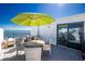 Enjoy the sun on this rooftop deck with modern furniture, water views, and sliding glass door at 2955 N Beach Rd # D123, Englewood, FL 34223