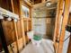 Bathroom featuring a tiled shower and a toilet, ready for renovation at 2985 N Beach Rd # Bv-5, Englewood, FL 34223