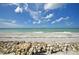 Beautiful beach with white sand and rocks in the foreground at 2985 N Beach Rd # Bv-5, Englewood, FL 34223