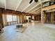 Spacious living room down to the studs with windows allowing ample natural light, offering a blank canvas for renovation at 2985 N Beach Rd # Bv-5, Englewood, FL 34223
