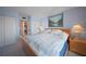 Bright bedroom with neutral carpet and blue paint, plus a peek at in-unit laundry at 311 Garvin St # 209C, Punta Gorda, FL 33950